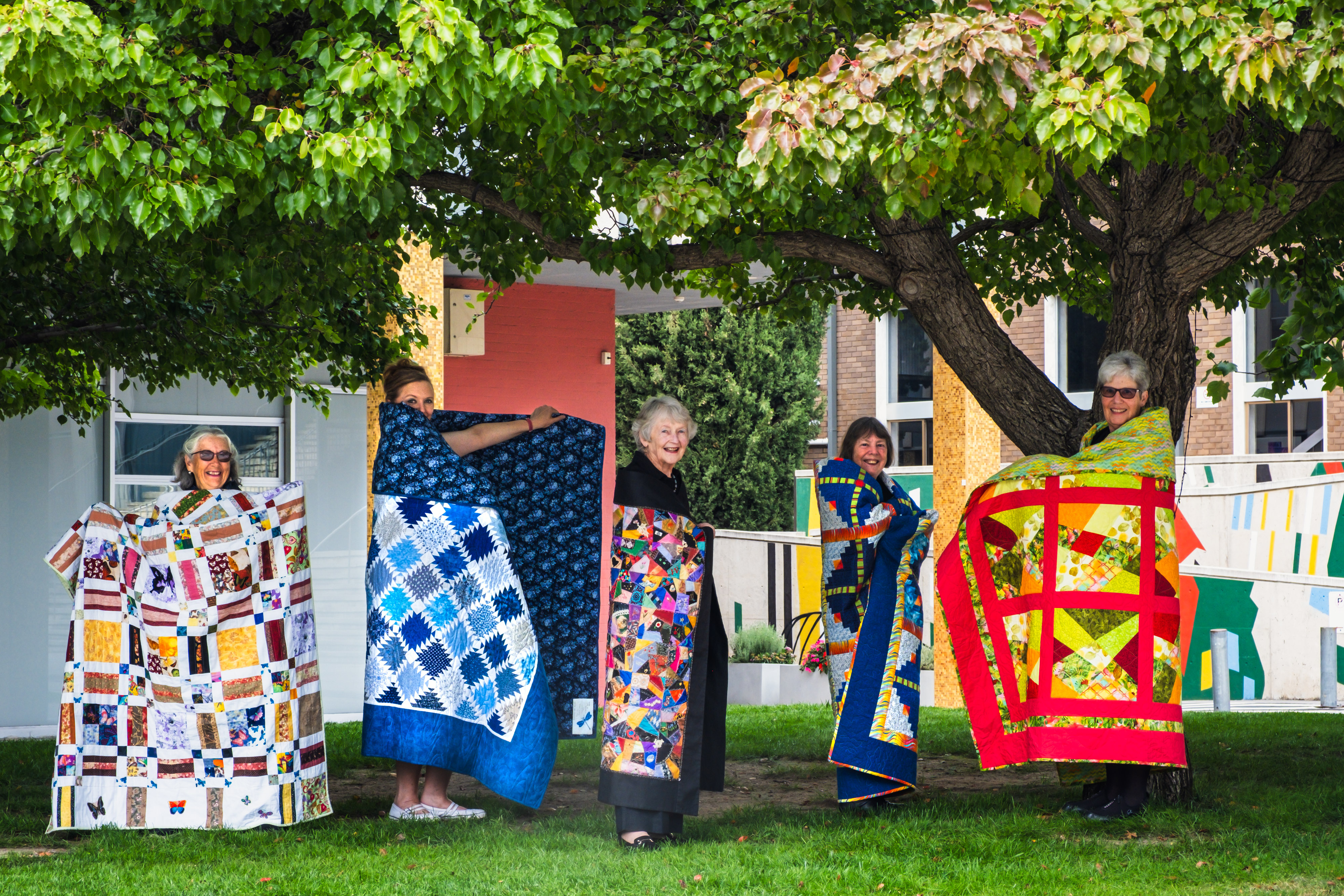 A group of Canberra Quilters displaying their quilts for the quilt walk
